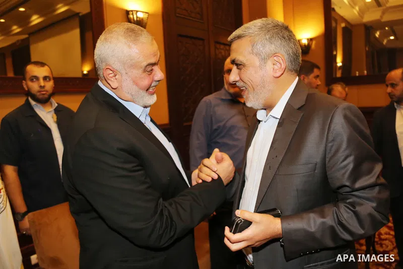 Palestinian Hamas Chief Ismail Haniyeh shakes hands with Hamas official, Izzat El-Reshiq, in Gaza City August 2, 2018. Hamas Chief Media Office