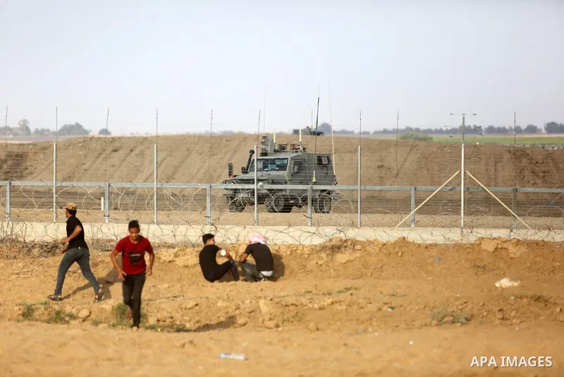 Palestinian protesters gather during clashes with Israeli troops in tents protest where Palestinian demand the right to return to their homeland at the Israel-Gaza border, in Khan Younis, in the southern Gaza Strip on Au...