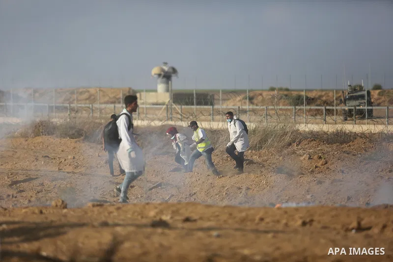 Palestinian protesters gather during clashes with Israeli troops in tents protest where Palestinian demand the right to return to their homeland at the Israel-Gaza border, in Khan Younis, in the southern Gaza Strip on Au...