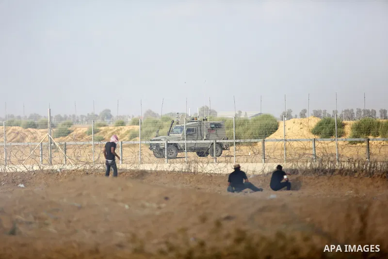 Palestinian protesters gather during clashes with Israeli troops in tents protest where Palestinian demand the right to return to their homeland at the Israel-Gaza border, in Khan Younis, in the southern Gaza Strip on Au...