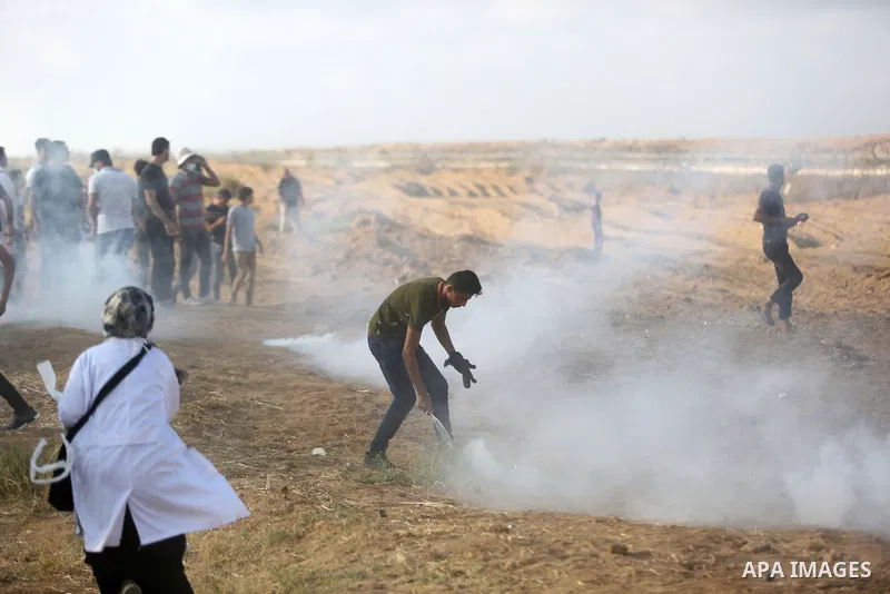 Palestinian protesters gather during clashes with Israeli troops in tents protest where Palestinian demand the right to return to their homeland at the Israel-Gaza border, in Khan Younis, in the southern Gaza Strip on Au...