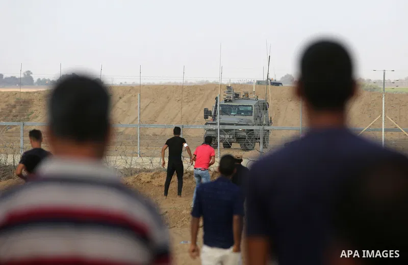 Palestinian protesters gather during clashes with Israeli troops in tents protest where Palestinian demand the right to return to their homeland at the Israel-Gaza border, in Khan Younis, in the southern Gaza Strip on Au...