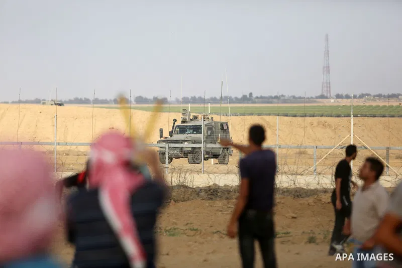Palestinian protesters gather during clashes with Israeli troops in tents protest where Palestinian demand the right to return to their homeland at the Israel-Gaza border, in Khan Younis, in the southern Gaza Strip on Au...