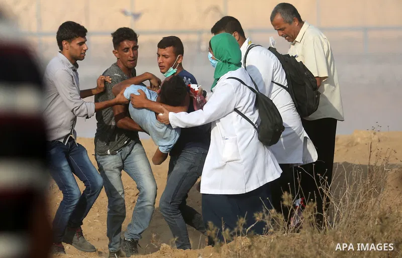 Palestinian protesters gather during clashes with Israeli troops in tents protest where Palestinian demand the right to return to their homeland at the Israel-Gaza border, in Khan Younis, in the southern Gaza Strip on Au...