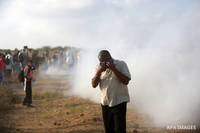 Palestinian protesters gather during clashes with Israeli troops in tents protest where Palestinian demand the right to return to their homeland at the Israel-Gaza border, in Khan Younis, in the southern Gaza Strip on Au...