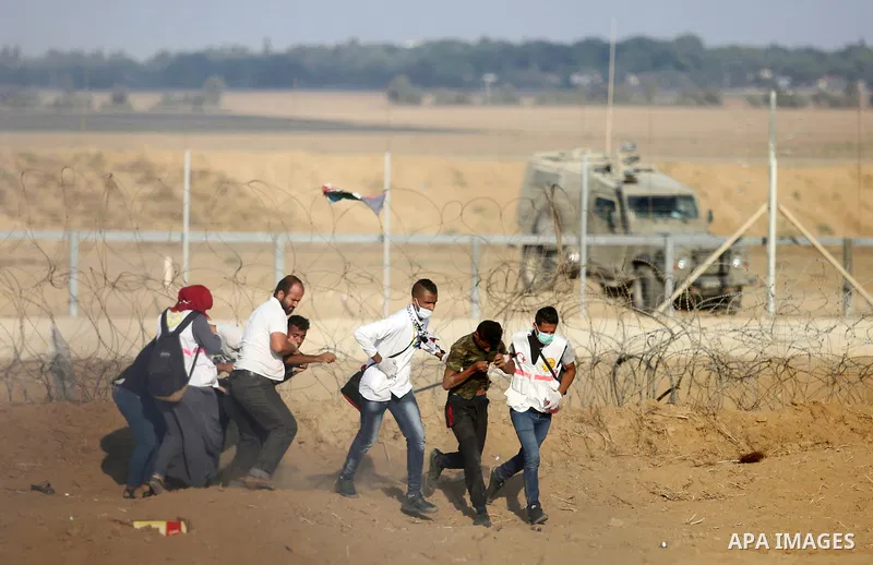 Palestinian protesters gather during clashes with Israeli troops in tents protest where Palestinian demand the right to return to their homeland at the Israel-Gaza border, in Khan Younis, in the southern Gaza Strip on Au...