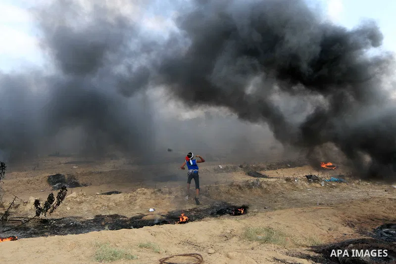 Palestinian protesters gather during clashes with Israeli troops in tents protest where Palestinian demand the right to return to their homeland at the Israel-Gaza border, in al-Bureij, in the center of Gaza Strip on Aug...