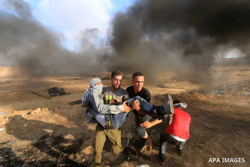 A wounded Palestinian protester is evacuated during clashes with Israeli troops in tents protest where Palestinian demand the right to return to their homeland at the Israel-Gaza border, in al-Bureij, in the center of Ga...