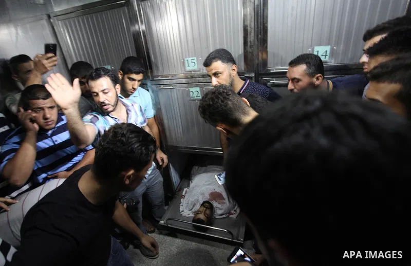 Relatives of Palestinian Ahmed Yaghi, 25, who was shot dead by Israeli troops during clashes at Gaza-Israel border mourn over his body at a morgue in a hospital in Gaza city on Aug. 03, 2018. Photo by Mahmoud Ajour