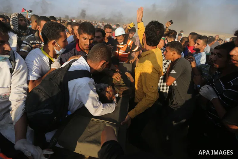 Palestinian protesters gather during clashes with Israeli troops in tents protest where Palestinian demand the right to return to their homeland at the Israel-Gaza border, in Khan Younis, in the southern Gaza Strip on Au...