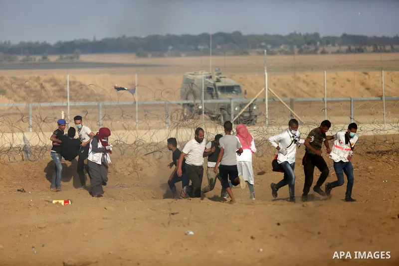 Palestinian protesters gather during clashes with Israeli troops in tents protest where Palestinian demand the right to return to their homeland at the Israel-Gaza border, in Khan Younis, in the southern Gaza Strip on Au...