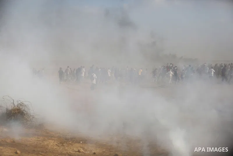 Palestinian protesters gather during clashes with Israeli troops in tents protest where Palestinian demand the right to return to their homeland at the Israel-Gaza border, in Khan Younis, in the southern Gaza Strip on Au...