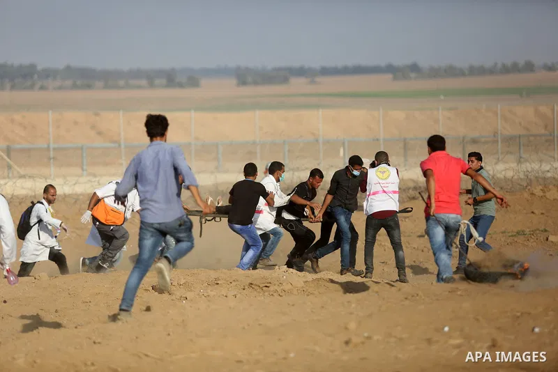 Palestinian protesters gather during clashes with Israeli troops in tents protest where Palestinian demand the right to return to their homeland at the Israel-Gaza border, in Khan Younis, in the southern Gaza Strip on Au...