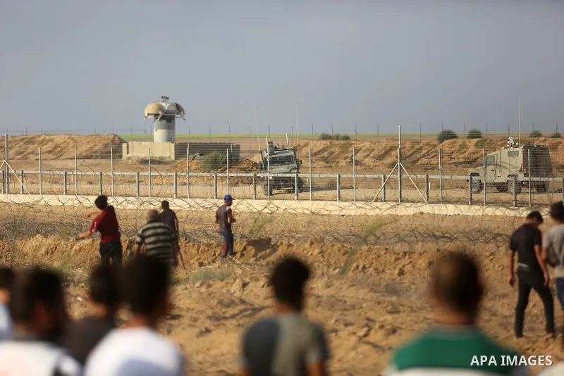Palestinian protesters gather during clashes with Israeli troops in tents protest where Palestinian demand the right to return to their homeland at the Israel-Gaza border, in Khan Younis, in the southern Gaza Strip on Au...