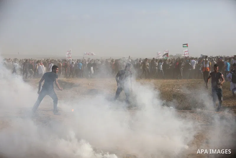 Palestinian protesters gather during clashes with Israeli troops in tents protest where Palestinian demand the right to return to their homeland at the Israel-Gaza border, in Khan Younis, in the southern Gaza Strip on Au...