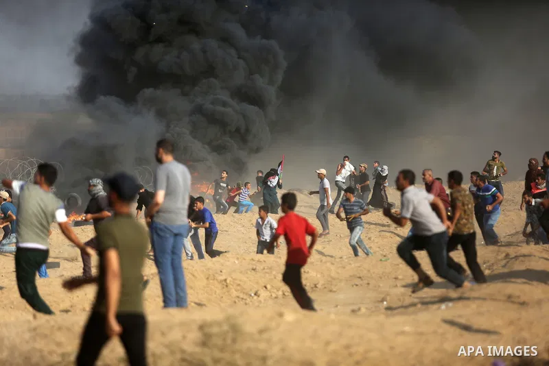 Palestinian protesters gather during clashes with Israeli troops in tents protest where Palestinian demand the right to return to their homeland at the Israel-Gaza border, in Khan Younis, in the southern Gaza Strip on Au...