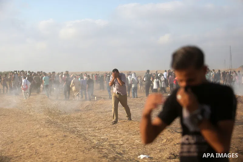 Palestinian protesters gather during clashes with Israeli troops in tents protest where Palestinian demand the right to return to their homeland at the Israel-Gaza border, in Khan Younis, in the southern Gaza Strip on Au...