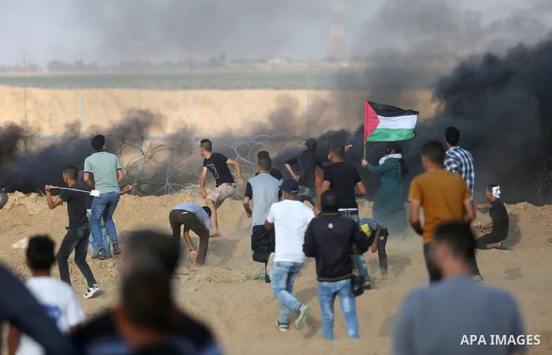 Palestinian protesters gather during clashes with Israeli troops in tents protest where Palestinian demand the right to return to their homeland at the Israel-Gaza border, in Khan Younis, in the southern Gaza Strip on Au...