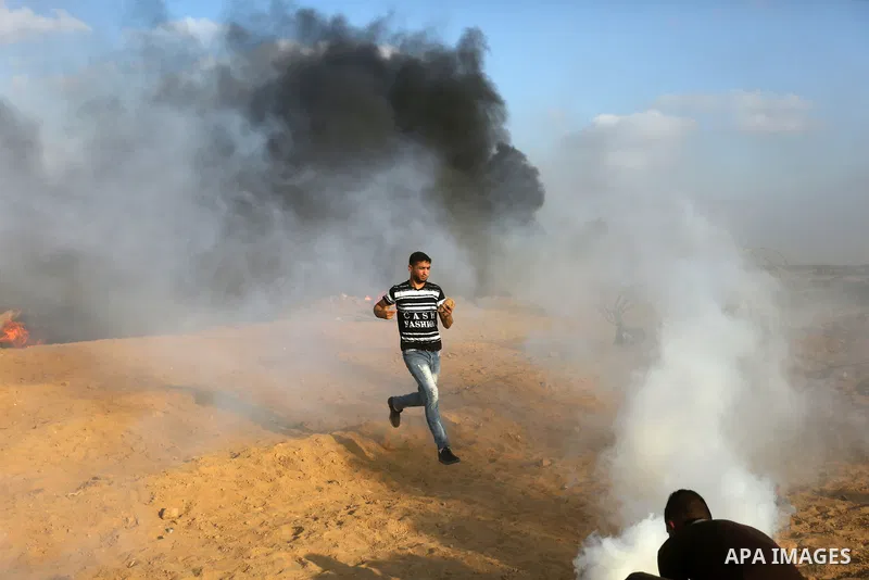 Palestinian protesters gather during clashes with Israeli troops in tents protest where Palestinian demand the right to return to their homeland at the Israel-Gaza border, in Khan Younis, in the southern Gaza Strip on Au...