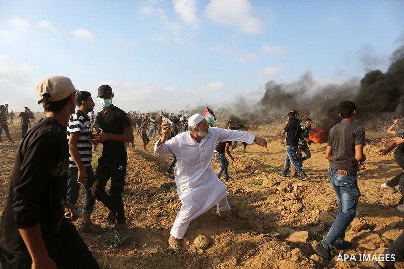 Palestinian protesters gather during clashes with Israeli troops in tents protest where Palestinian demand the right to return to their homeland at the Israel-Gaza border, in Khan Younis, in the southern Gaza Strip on Au...