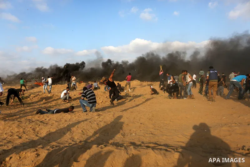 Palestinian protesters gather during clashes with Israeli troops in tents protest where Palestinian demand the right to return to their homeland at the Israel-Gaza border, in Khan Younis, in the southern Gaza Strip on Au...