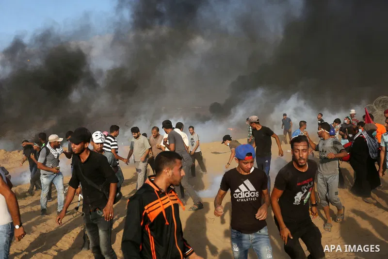Palestinian protesters gather during clashes with Israeli troops in tents protest where Palestinian demand the right to return to their homeland at the Israel-Gaza border, in Khan Younis, in the southern Gaza Strip on Au...
