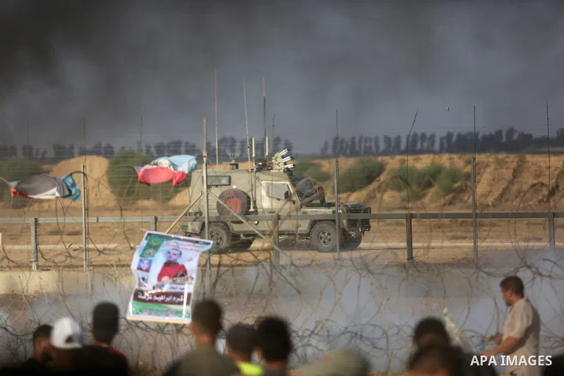 Palestinian protesters gather during clashes with Israeli troops in tents protest where Palestinian demand the right to return to their homeland at the Israel-Gaza border, in Khan Younis, in the southern Gaza Strip on Au...