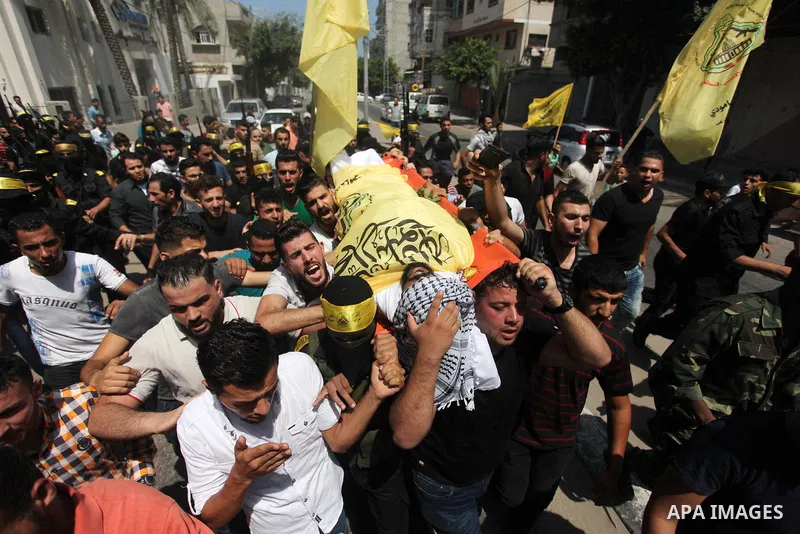 Mourners carry the body of Palestinian Ahmed Yaghi, 25, who was shot dead by Israeli troops during clashes along the border the previous day, during his funeral in Gaza city on Aug. 04, 2018. Photo by Mahmoud Ajour