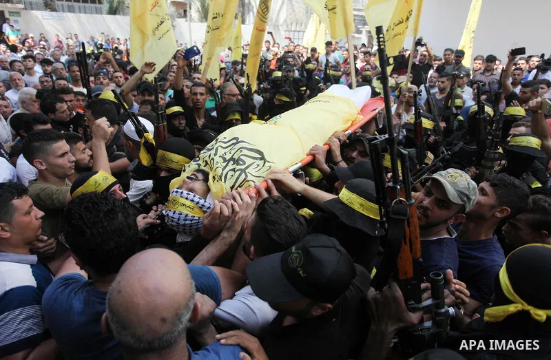 Mourners carry the body of Palestinian Ahmed Yaghi, 25, who was shot dead by Israeli troops during clashes along the border the previous day, during his funeral in Gaza city on Aug. 04, 2018. Photo by Mahmoud Ajour