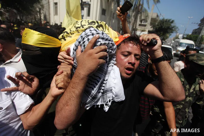 Mourners carry the body of Palestinian Ahmed Yaghi, 25, who was shot dead by Israeli troops during clashes along the border the previous day, during his funeral in Gaza city on Aug. 04, 2018. Photo by Mahmoud Ajour