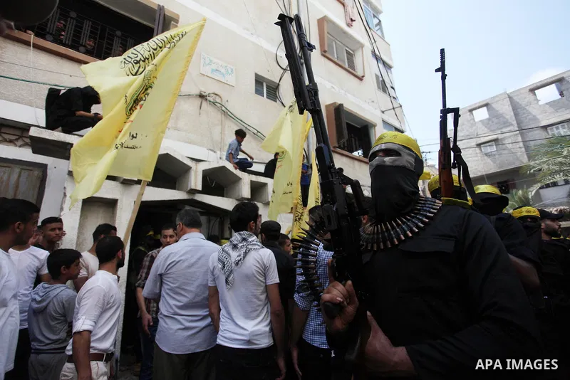 Palestinian militants hold their weapons during the funeral of Ahmed Yaghi, 25, who was shot dead by Israeli troops during clashes along the border the previous day, in Gaza city on Aug. 04, 2018. Photo by Mahmoud Ajour