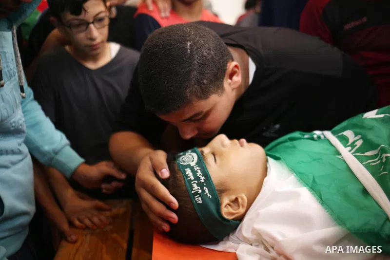 Relatives of Palestinian teenager Moath Al-Sori, who died from wounds suffered during clashes with Israeli troops along the border the previous day, mourn over his body during his funeral in Nusairat in the center of Gaz...