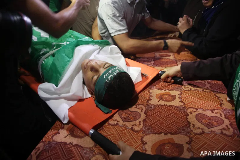 Relatives of Palestinian teenager Moath Al-Sori, who died from wounds suffered during clashes with Israeli troops along the border the previous day, mourn over his body during his funeral in Nusairat in the center of Gaz...