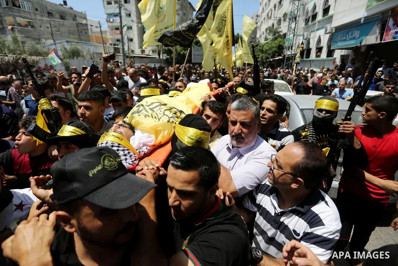 Mourners carry the body of Palestinian Ahmed Yaghi, 25, who was shot dead by Israeli troops during clashes along the border the previous day, during his funeral in Gaza city on Aug. 04, 2018. Photo by Ashraf Amra
