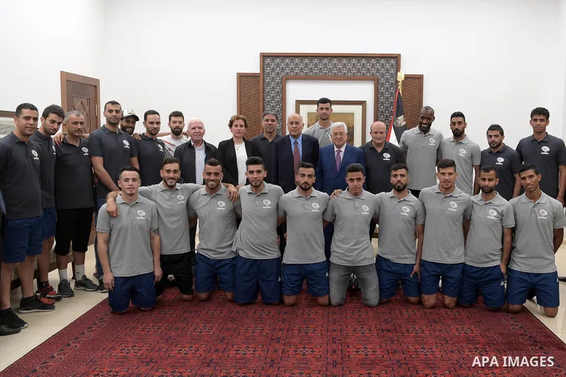 Palestinian President Mahmoud Abbas meets with the Palestinian team for football in the West Bank city of Ramallah on August 4, 2018. Photo by Thaer Ganaim