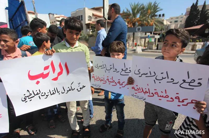 Sons of the Palestinian prisoners take part in a protest to demand the salaries of their fathers at a tent in front of the Council of Ministers headquarter in Gaza City, on August 5, 2018. Photo by Mahmoud Ajour
