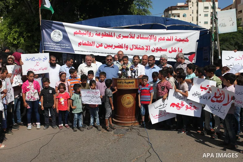 Sons of the Palestinian prisoners take part in a protest to demand the salaries of their fathers at a tent in front of the Council of Ministers headquarter in Gaza City, on August 5, 2018. Photo by Mahmoud Ajour
