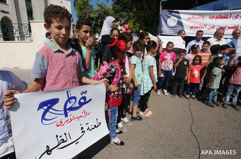 Sons of the Palestinian prisoners take part in a protest to demand the salaries of their fathers at a tent in front of the Council of Ministers headquarter in Gaza City, on August 5, 2018. Photo by Mahmoud Ajour