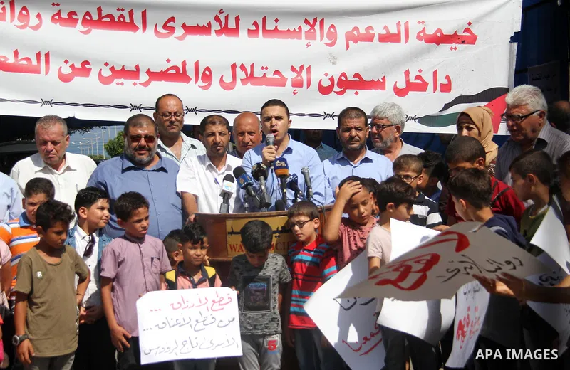 Sons of the Palestinian prisoners take part in a protest to demand the salaries of their fathers at a tent in front of the Council of Ministers headquarter in Gaza City, on August 5, 2018. Photo by Mahmoud Ajour