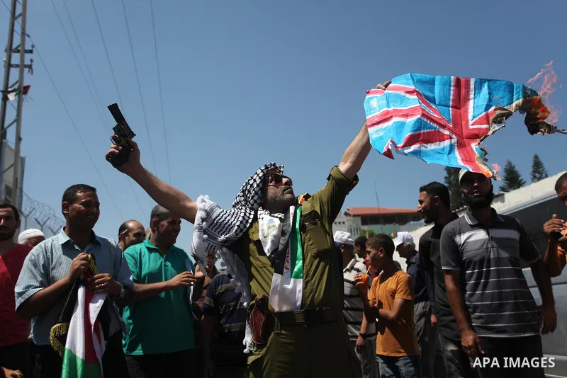Palestinians hold banners during a protest against a U.S. decision to cut aid, in front of the headquarters United Nations Relief and Works Agency (UNRWA), in Gaza City, on August 6, 2018. Photo by Mahmoud Ajour