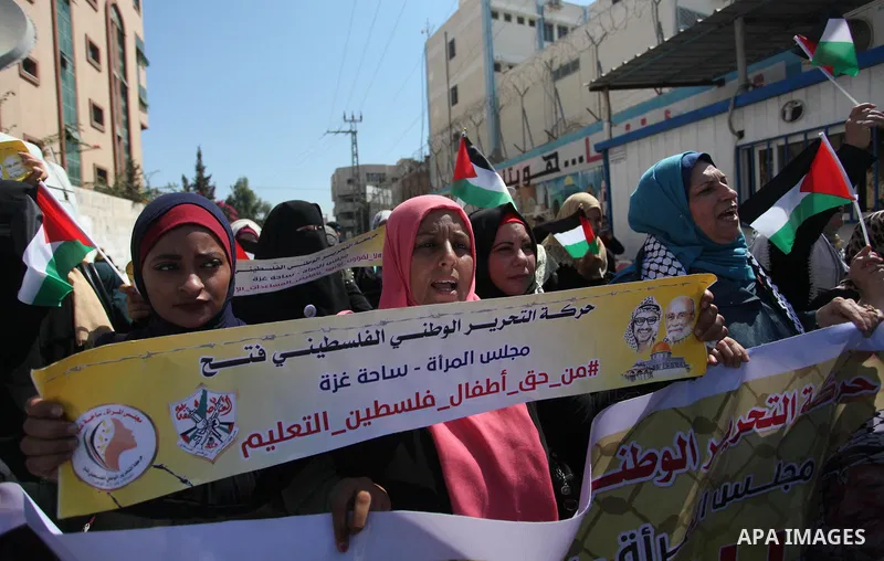Palestinians hold banners during a protest against a U.S. decision to cut aid, in front of the headquarters United Nations Relief and Works Agency (UNRWA), in Gaza City, on August 6, 2018. Photo by Mahmoud Ajour