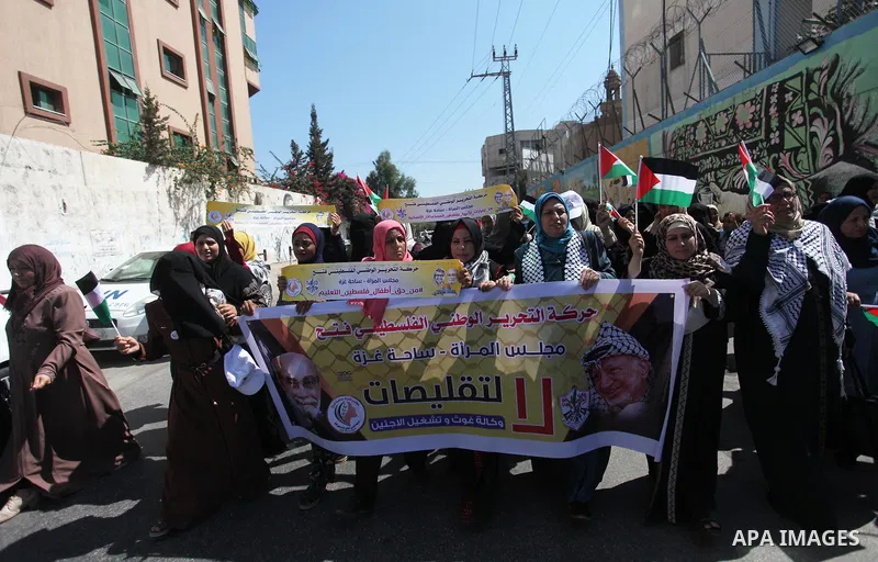 Palestinians hold banners during a protest against a U.S. decision to cut aid, in front of the headquarters United Nations Relief and Works Agency (UNRWA), in Gaza City, on August 6, 2018. Photo by Mahmoud Ajour