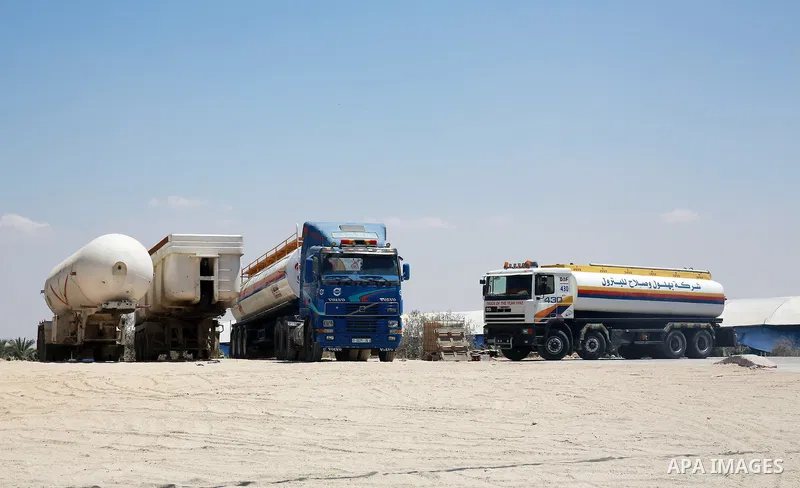 Trucks loaded with cooking gas imported from Egypt are seen at a gas station in Rafah, in the southern Gaza Strip August 6, 2018. Egypt has allowed domestic gas deliveries into the blockaded Gaza Strip for the first time...