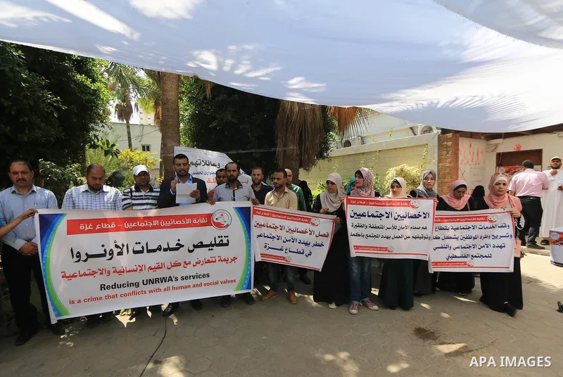 Palestinian employees of United Nations Relief and Works Agency (UNRWA) take part in a protest against a U.S. decision to cut aid, inside its offices, in Gaza City, on Aug. 07 2018. Photo by Mahmoud Khattab