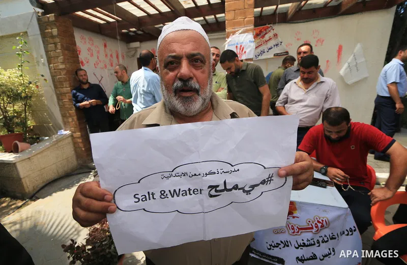 Palestinian employees of United Nations Relief and Works Agency (UNRWA) take part in a protest against a U.S. decision to cut aid, inside its offices, in Gaza City, on Aug. 07 2018. Photo by Mahmoud Khattab