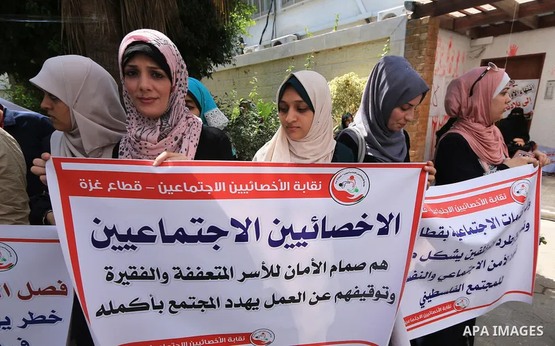 Palestinian employees of United Nations Relief and Works Agency (UNRWA) take part in a protest against a U.S. decision to cut aid, inside its offices, in Gaza City, on Aug. 07 2018. Photo by Mahmoud Khattab