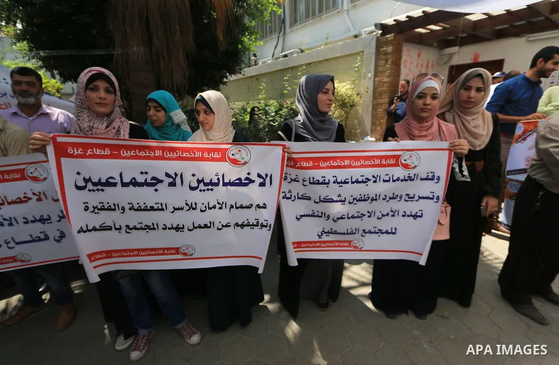 Palestinian employees of United Nations Relief and Works Agency (UNRWA) take part in a protest against a U.S. decision to cut aid, inside its offices, in Gaza City, on Aug. 07 2018. Photo by Mahmoud Khattab