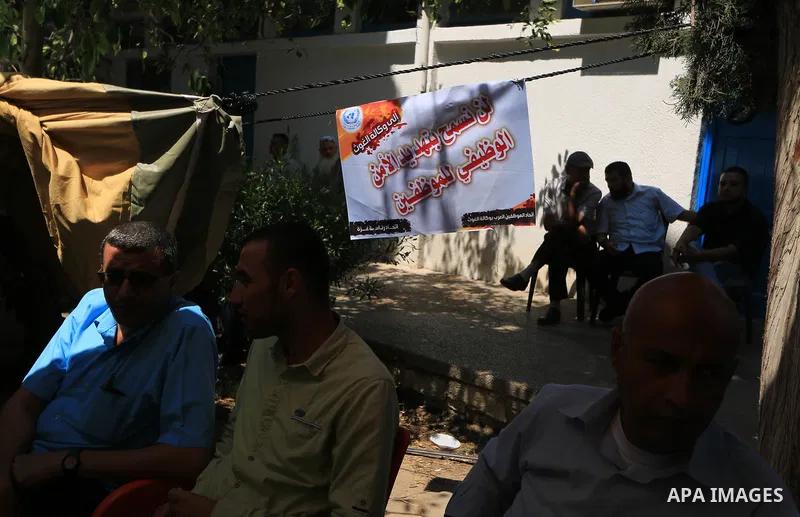 Palestinian employees of United Nations Relief and Works Agency (UNRWA) take part in a protest against a U.S. decision to cut aid, inside its offices, in Gaza City, on Aug. 07 2018. Photo by Mahmoud Khattab