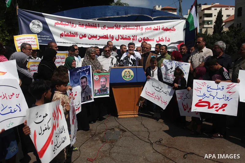 Palestinians take part in a protest to show solidarity with Palestinian prisoners are paid their salaries in Israeli jails in front of the Council of Ministers headquarter in Gaza City, on August 7, 2018. Photo by Mahmou...