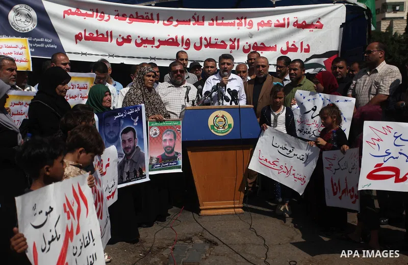 Palestinians take part in a protest to show solidarity with Palestinian prisoners are paid their salaries in Israeli jails in front of the Council of Ministers headquarter in Gaza City, on August 7, 2018. Photo by Mahmou...